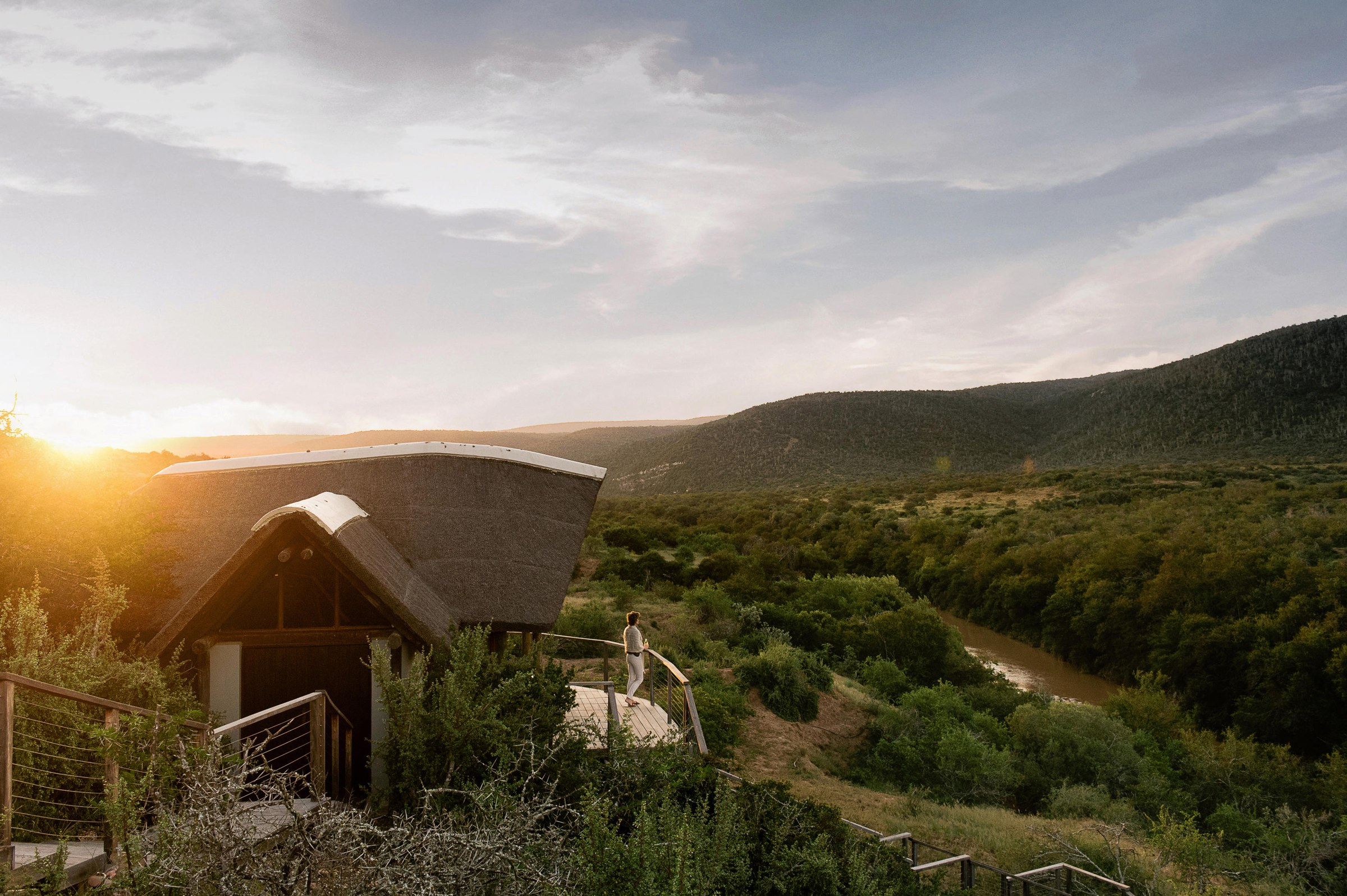 Luxury safari lodge overlooking African wilderness at sunrise