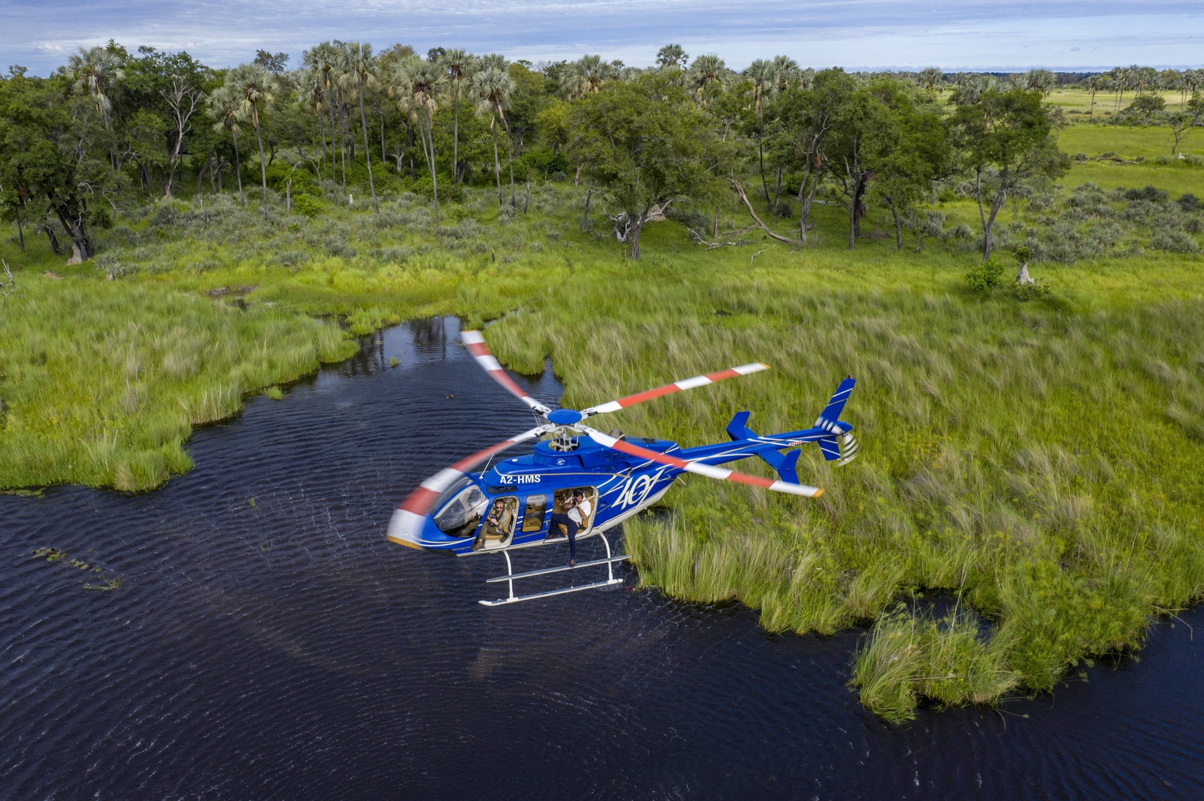 A helicopter flying over the waterways of Botswana’s Okavango Delta.