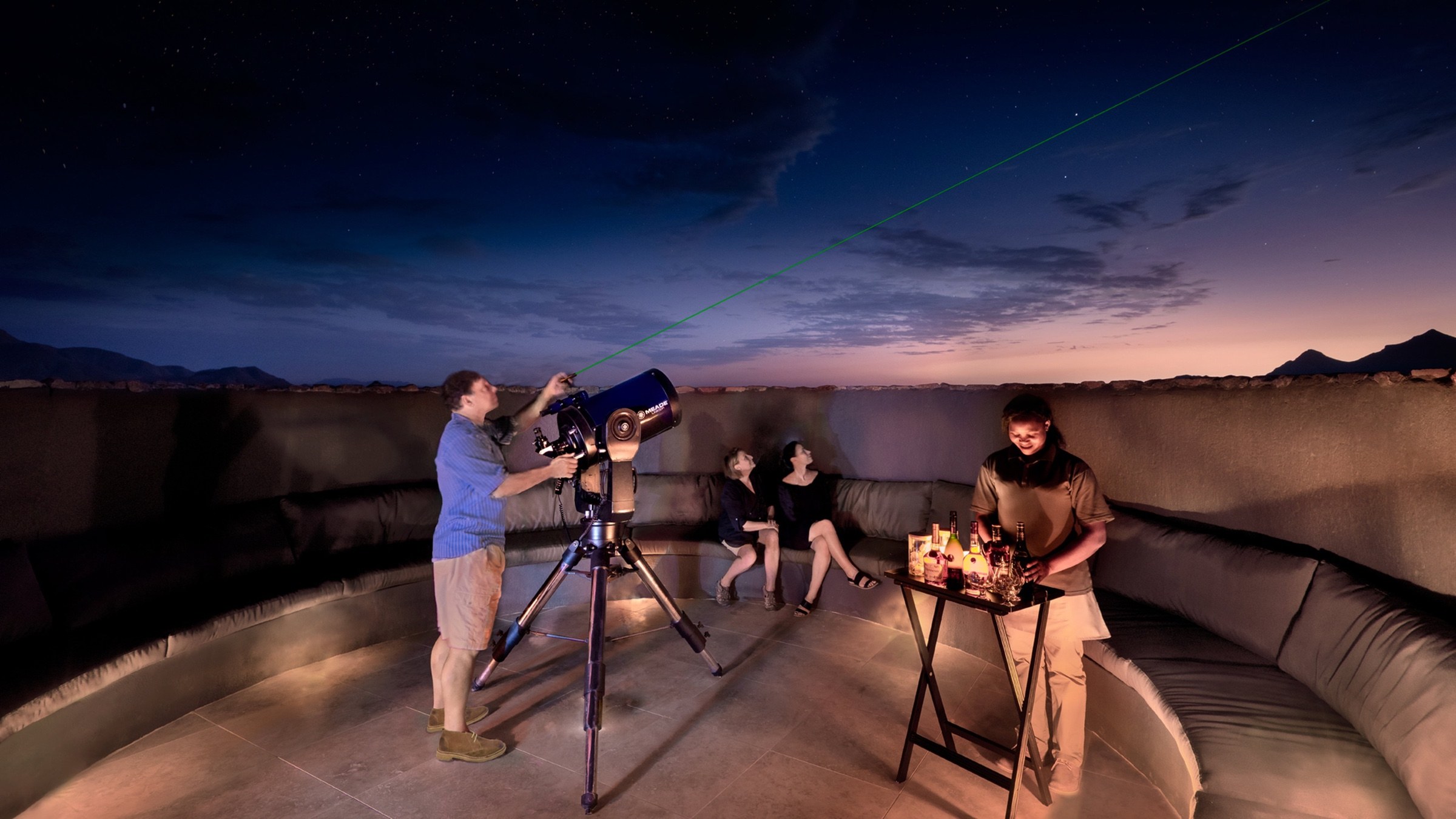 Guests stargazing with a telescope at a Namibian lodge