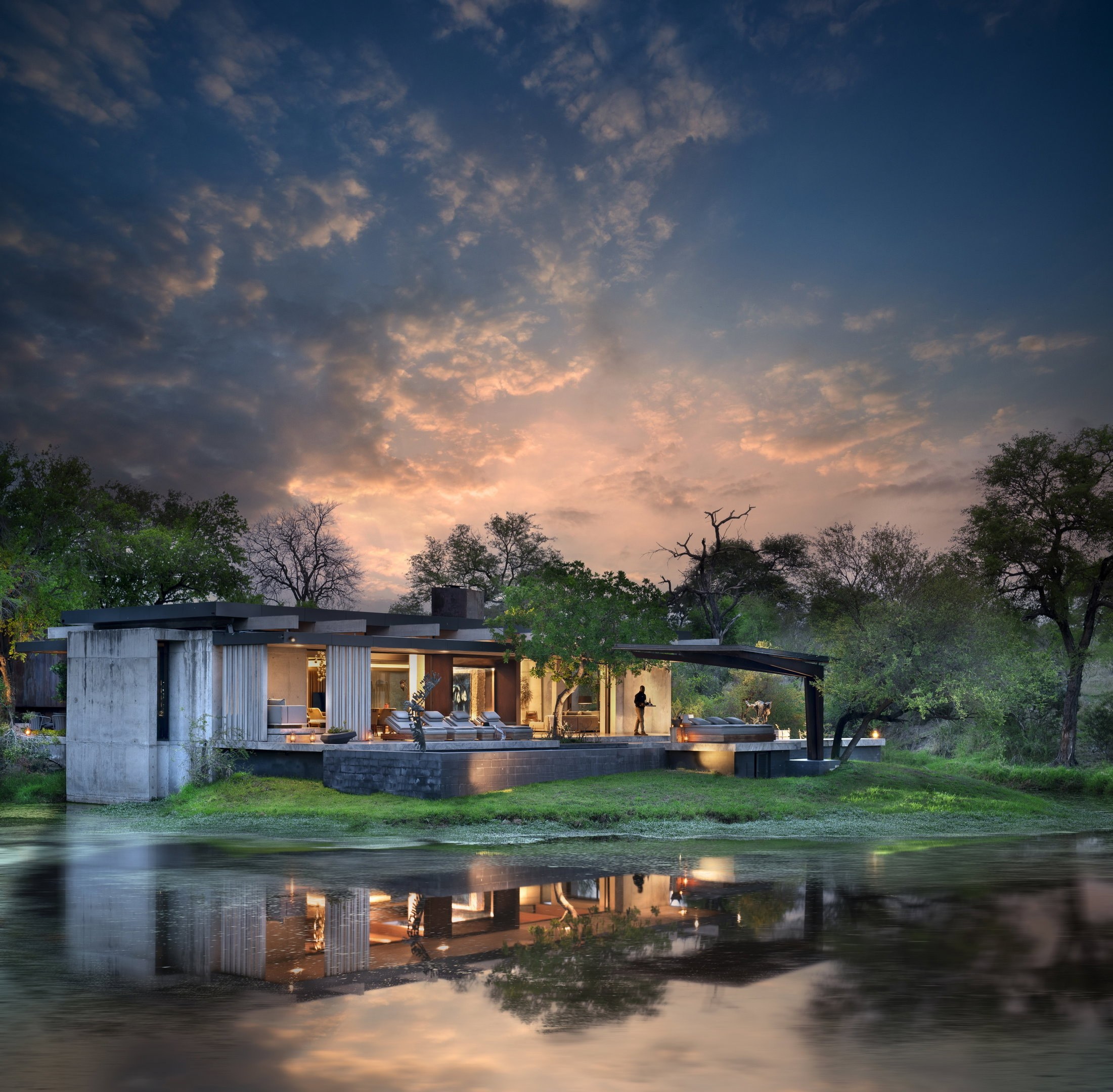 Private safari lodge beside a river at dusk in South Africa.