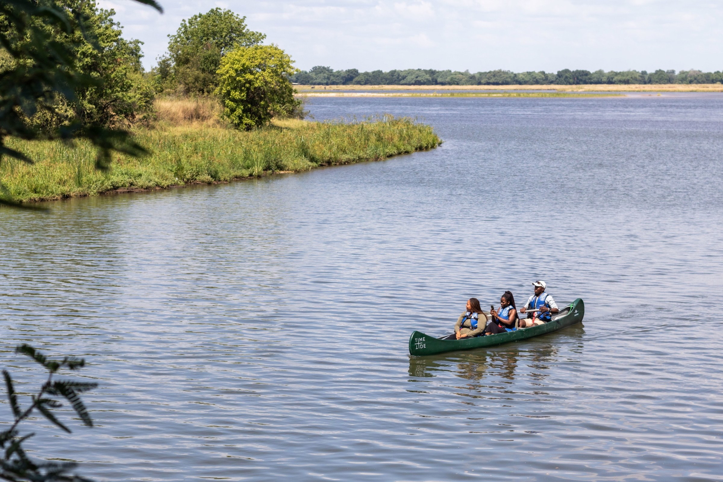 Guests and a guide in a canoe on the Lower Zambezi River