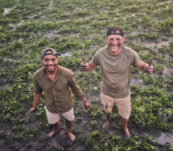 Zannon James and a fellow traveller standing on muddy ground in Mana Pools