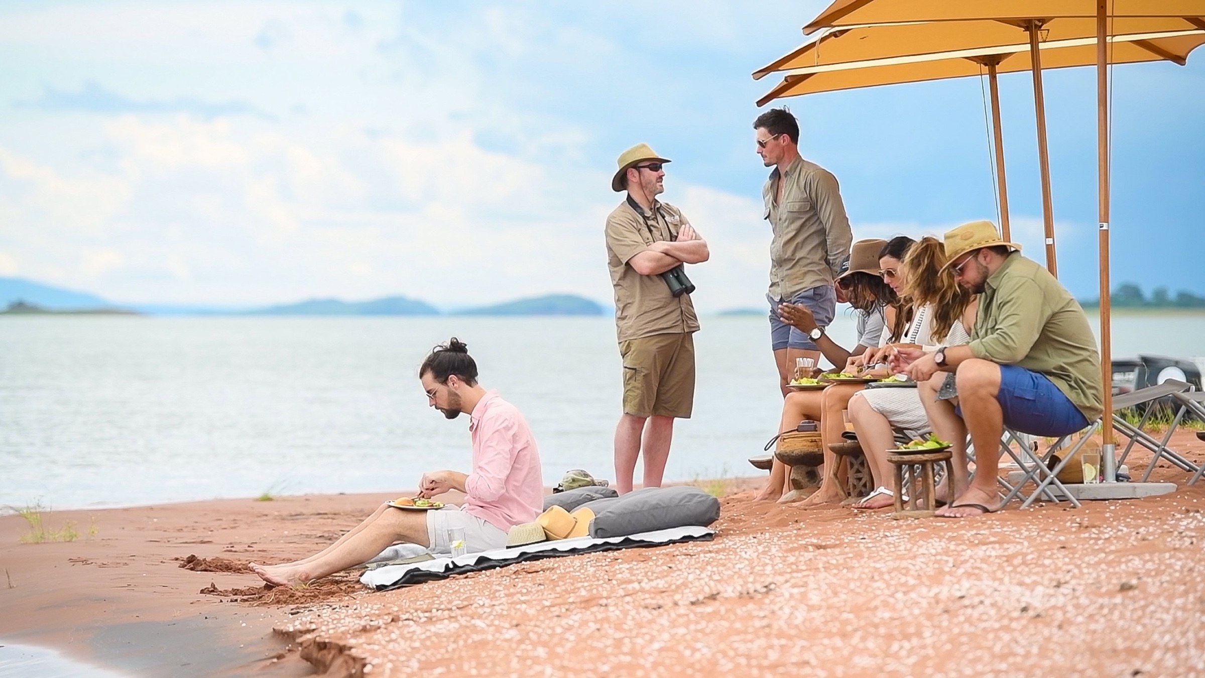 Guests and a guide enjoying a picnic beside Lake Kariba