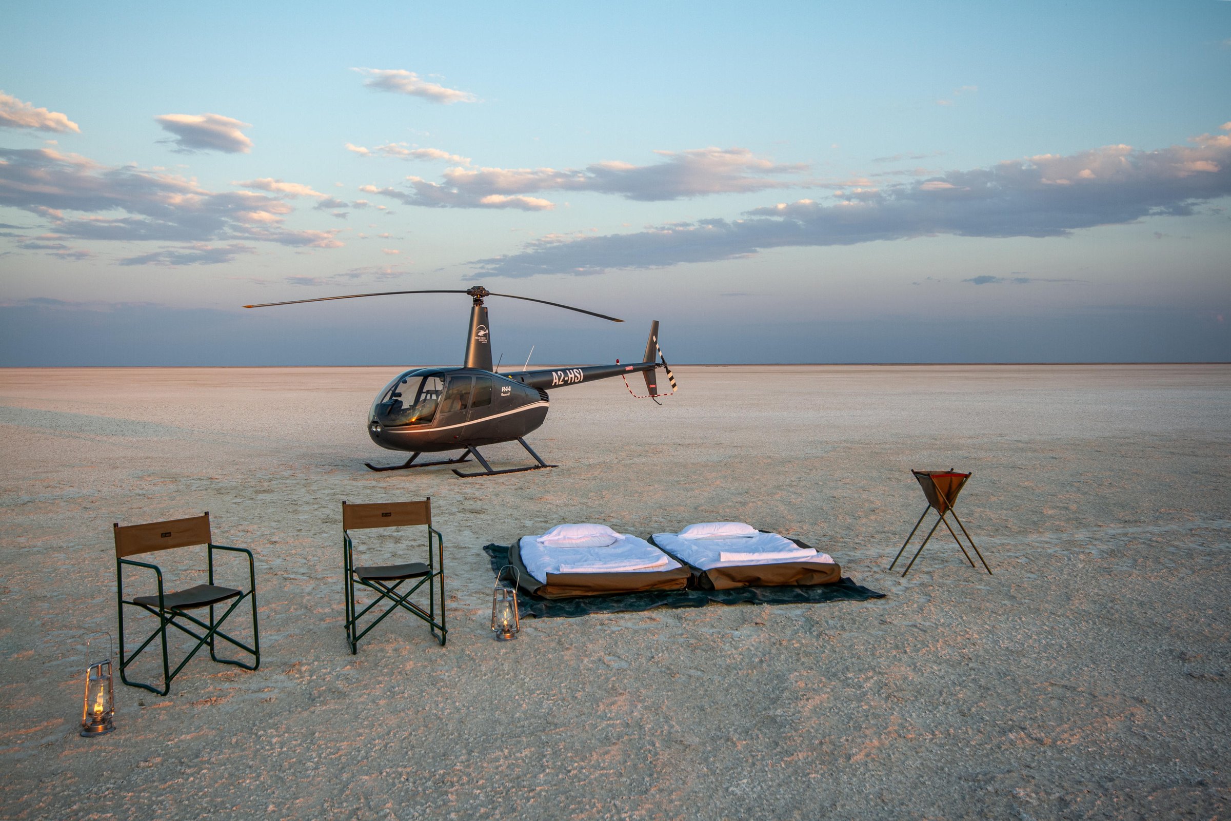 Helicopter and private setup on Botswana salt pans at twilight