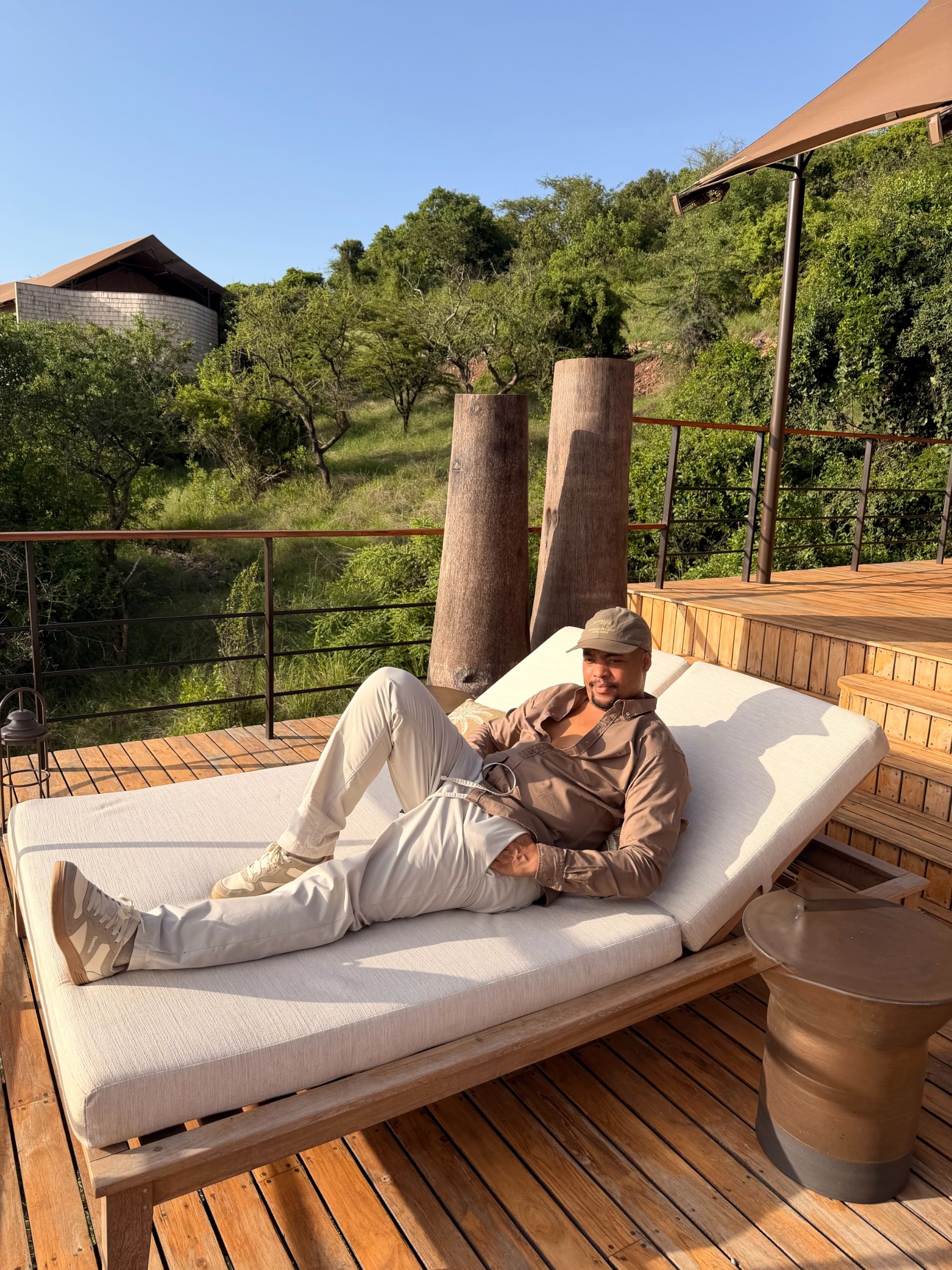African travel specialist Zannon James relaxing on a lodge deck at Laba Laba Grumeti in Tanzania