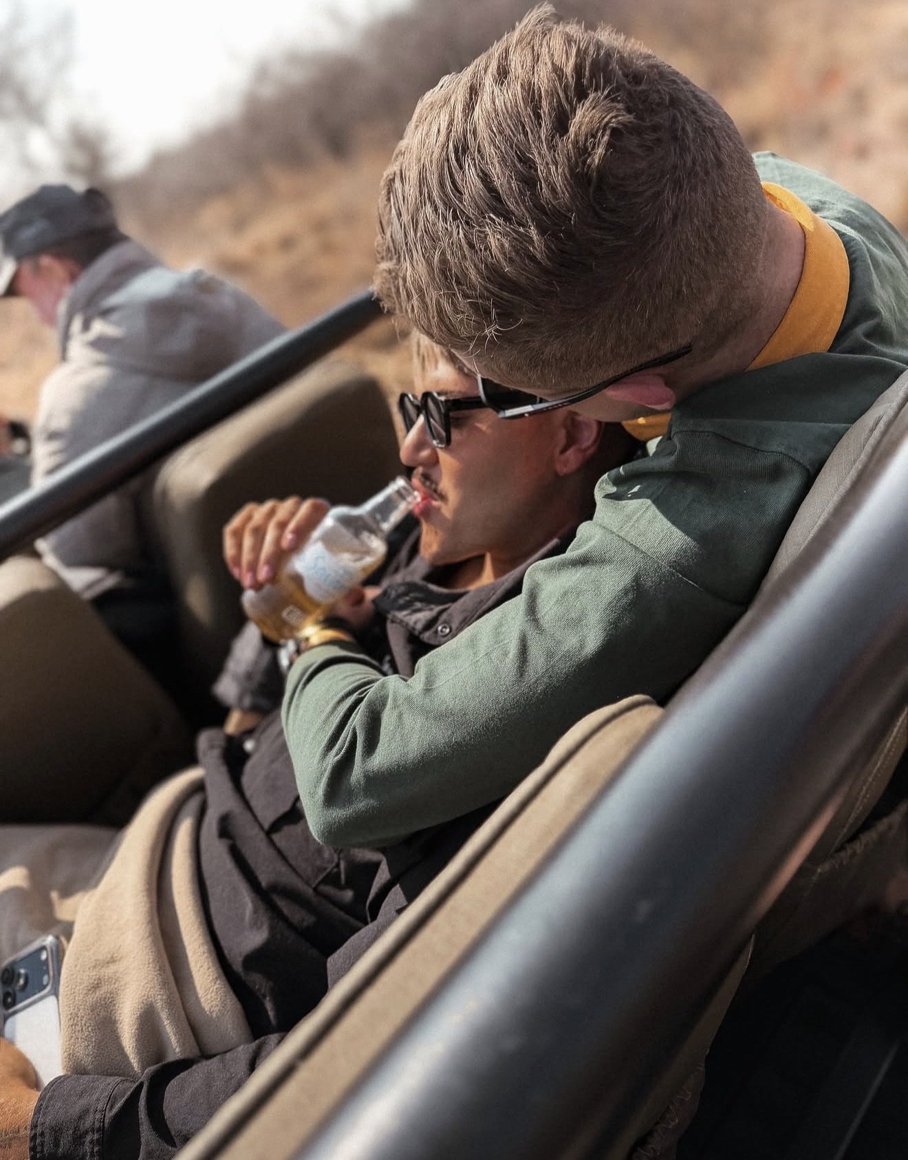 A gay couple together in an open safari vehicle in South Africa