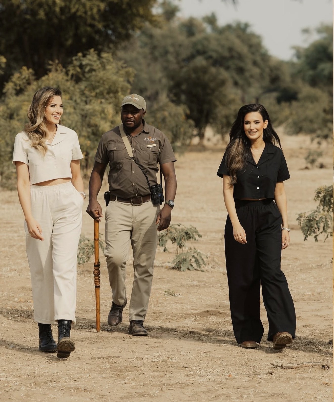 Two guests walking with a guide in Zambia