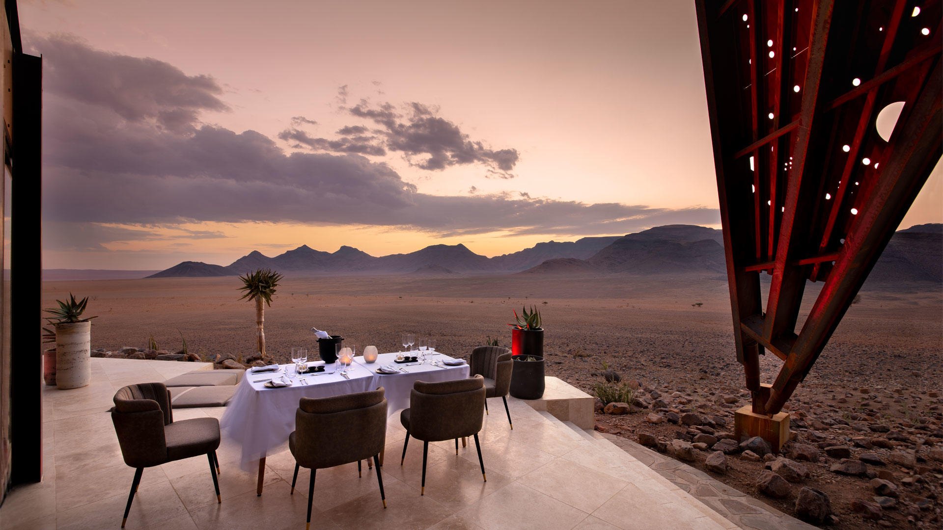 Luxury desert dining scene overlooking Namibia's dunes