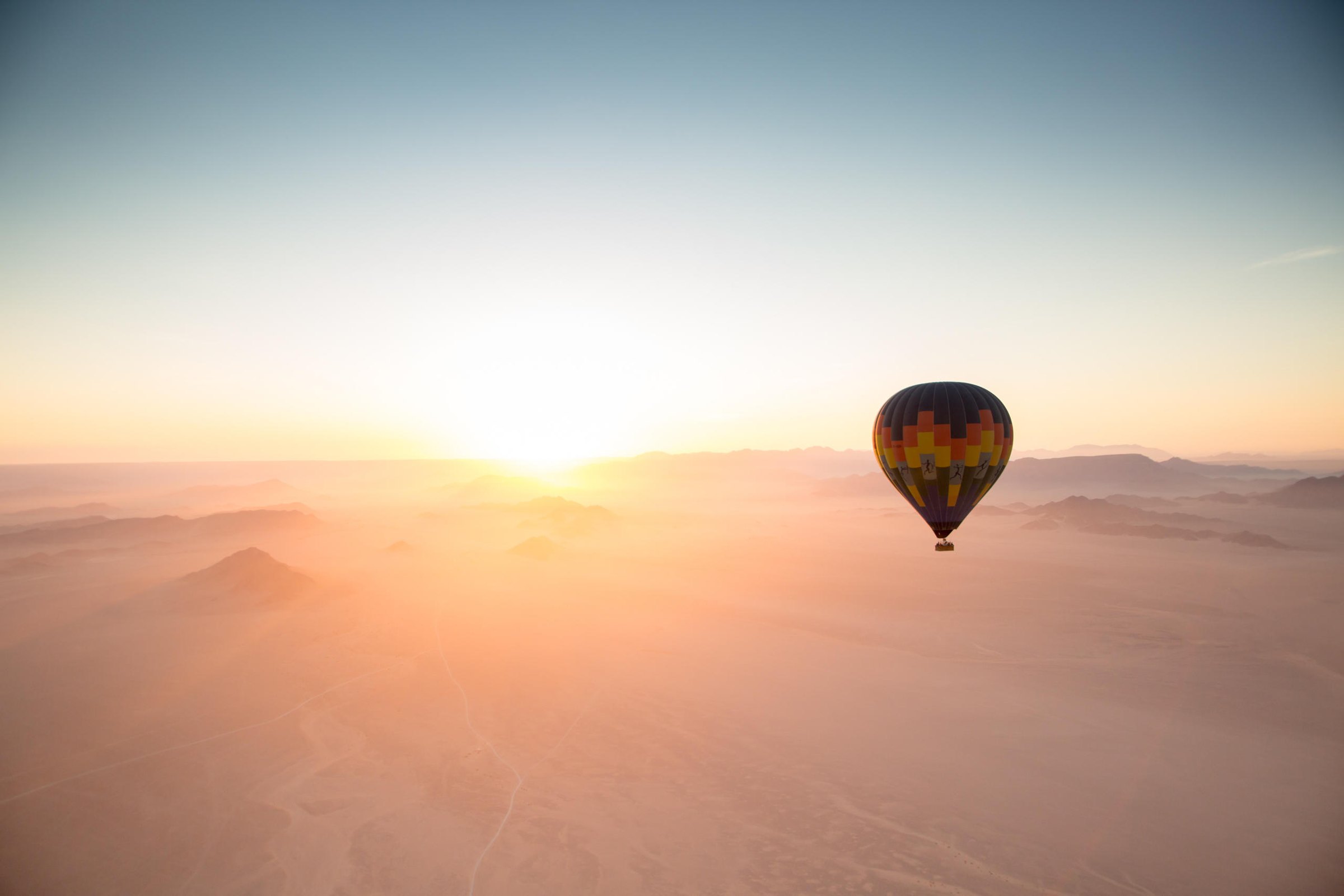 Hot air balloon over the Namib Desert at sunrise