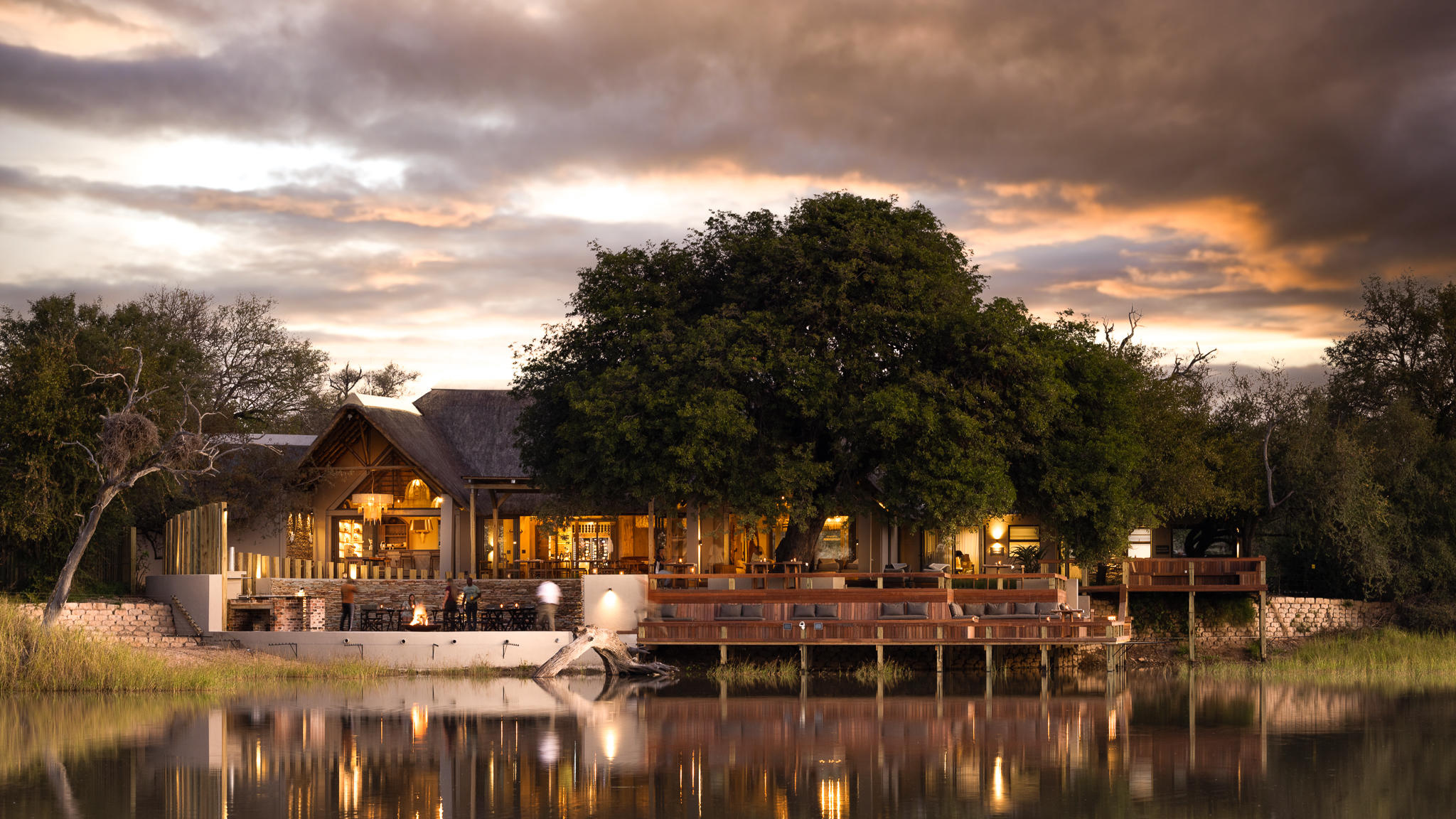 Simbavati Waterside lodge at dusk beside the water